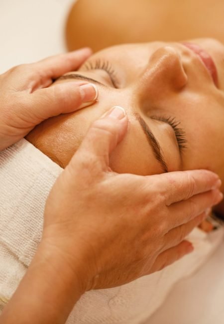 Close-up of young woman enjoying in head massage during beauty treatment at the spa.